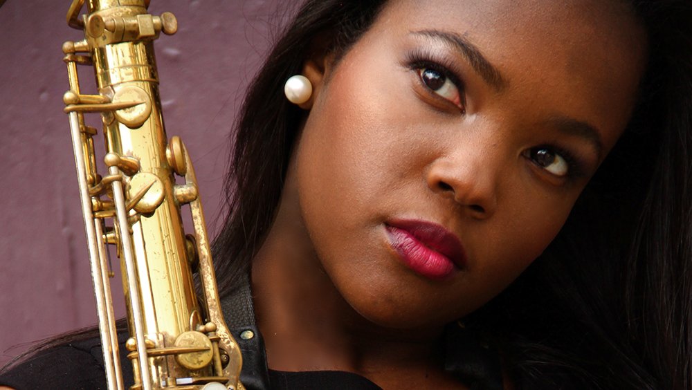 Close-up of Camille Thurman and her saxophone