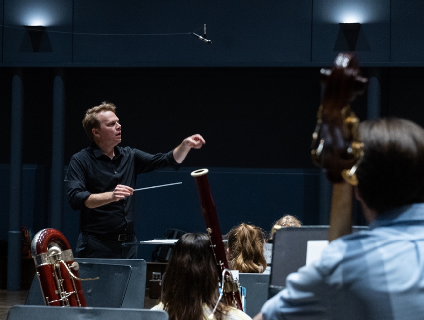 man conducting a band on stage